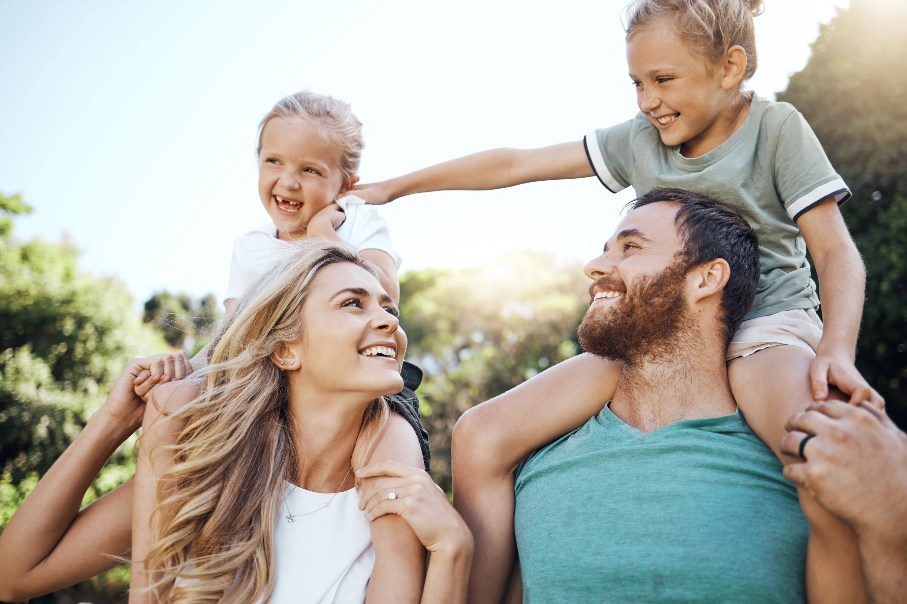 Family gathering together outdoors at golden hour